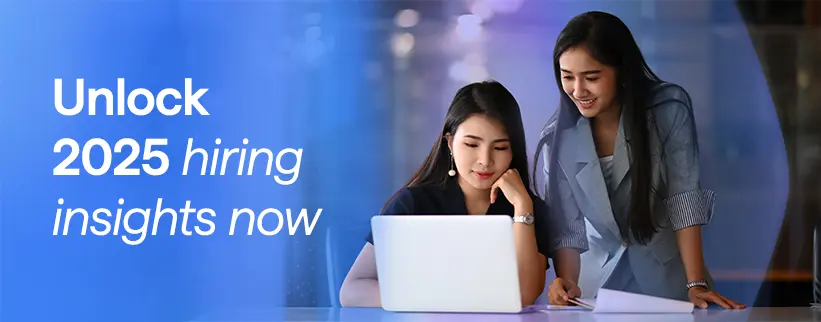Two professional women looking at a laptop together