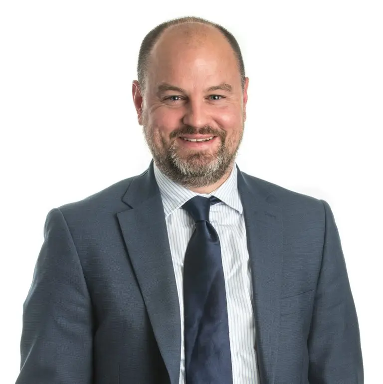 Business professional man in a suit smiling at the camera