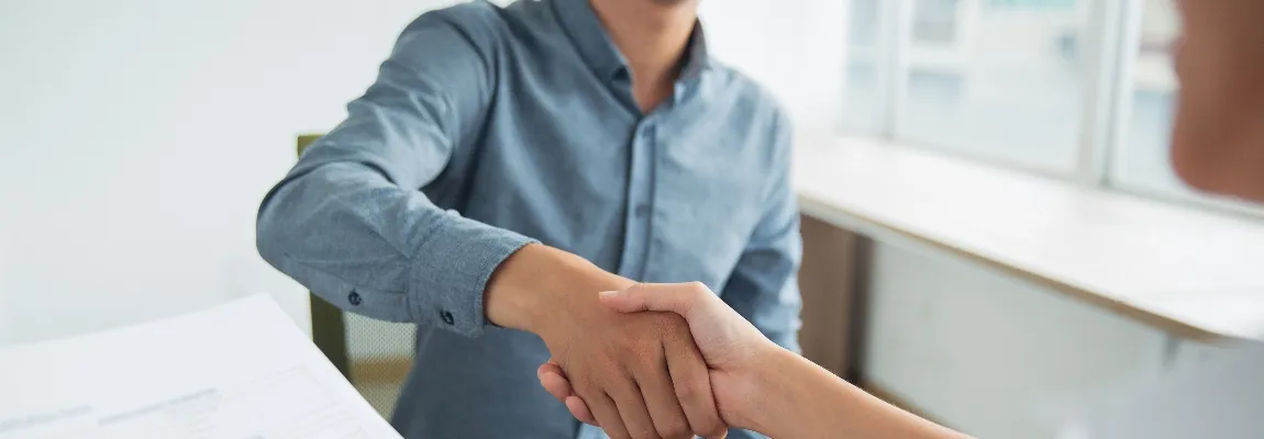 Jobseeker and interviewer shaking hands during an interview