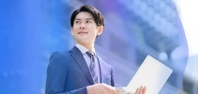 Japanese professional with laptop representing salary growth in Japan — 2025 Pulse of Recruitment