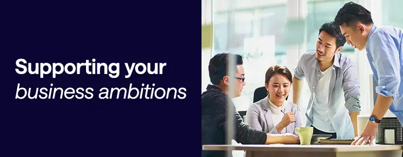 Four professionals in a modern Japan office discussing business strategy — supporting your business ambitions with Hays Japan recruitment and workforce solutions.