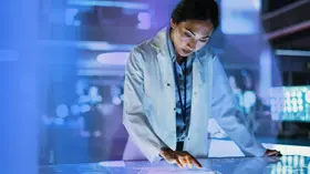 Life sciences researcher using a touch-screen in laboratory 